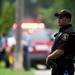 A police officer stands near the perimeter of the scene of a house explosion on Gattegno Street in Ypsilanti Township on Sunday, July 7. Daniel Brenner I AnnArbor.com